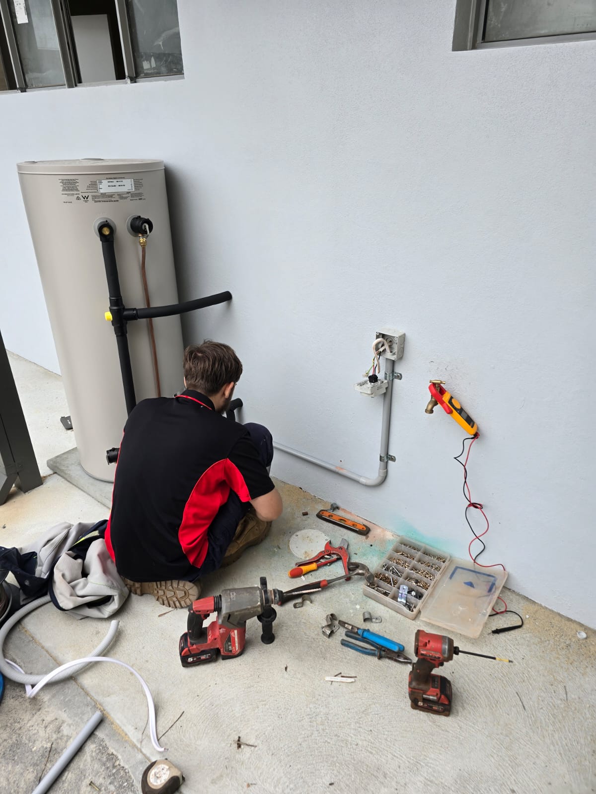 Commercial hot water system electrical installation in Malaga building with professional circuit wiring and safety switches