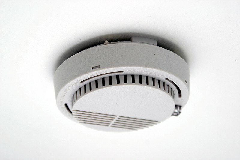 Professional smoke alarm installation showing hardwired photoelectric smoke detector for Perth home safety